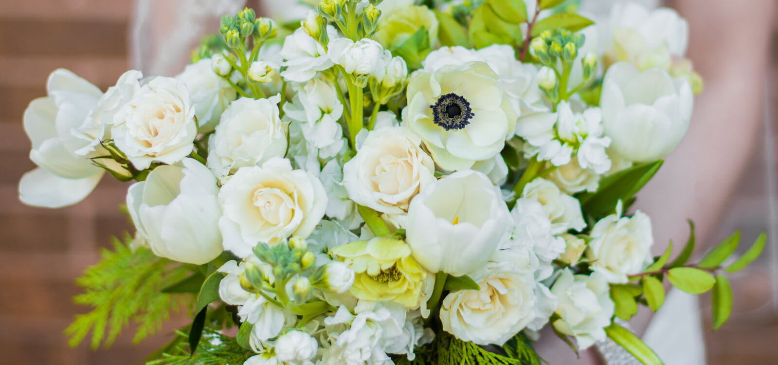 All-white anemone and ranunculus bridal bouquet