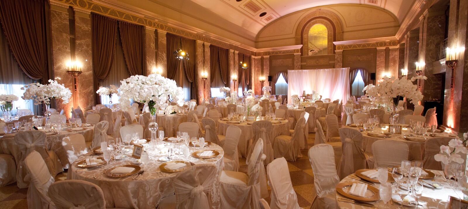 Elegant wedding reception ballroom with floral centerpieces