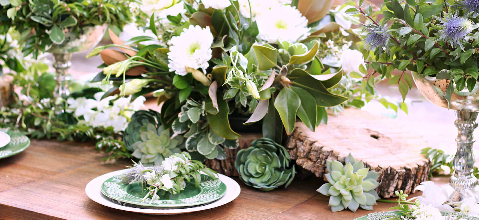 Garden-style reception tablescape with succulents and greenery