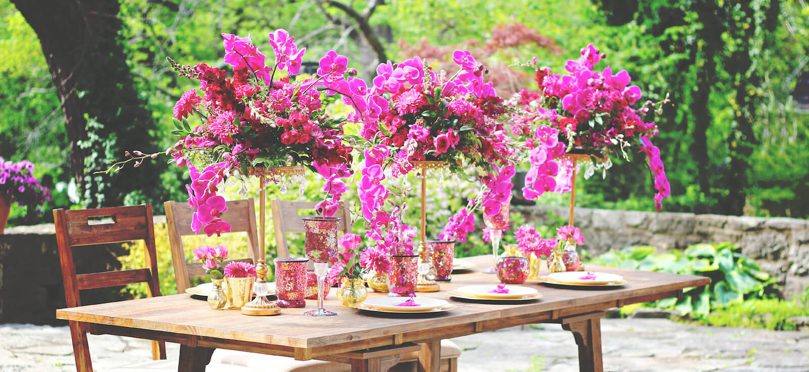 Pink garden reception tablescape with lush blooms