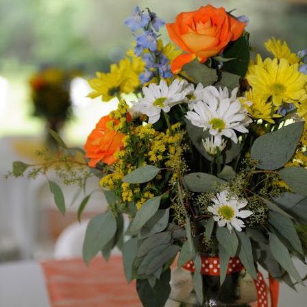 Colorful reception centerpiece with daisies and roses